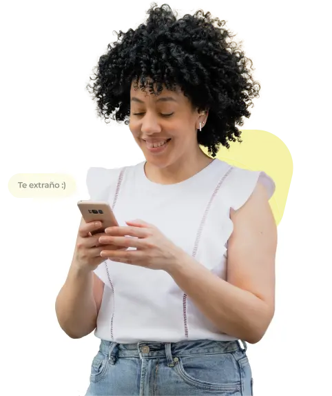 A woman with curly hair looking at her phone with a message pop-up that says "I miss you"
